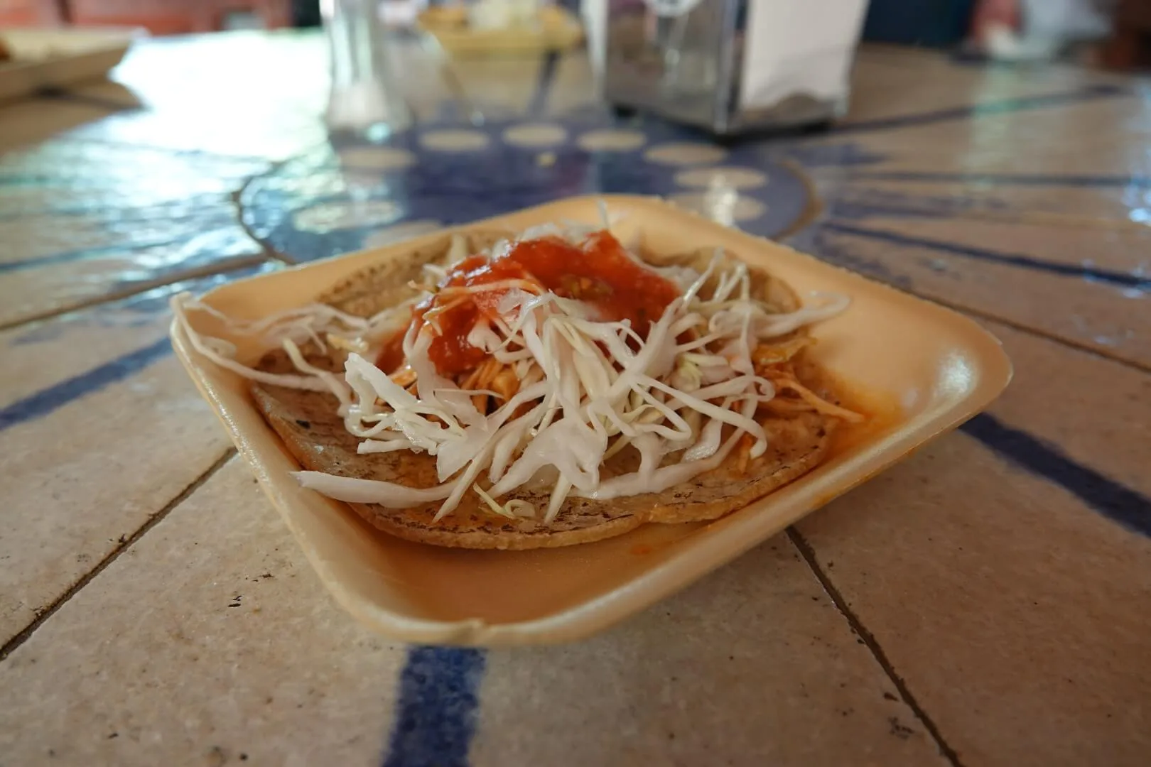 A delicious taco with cabbage and salsa.