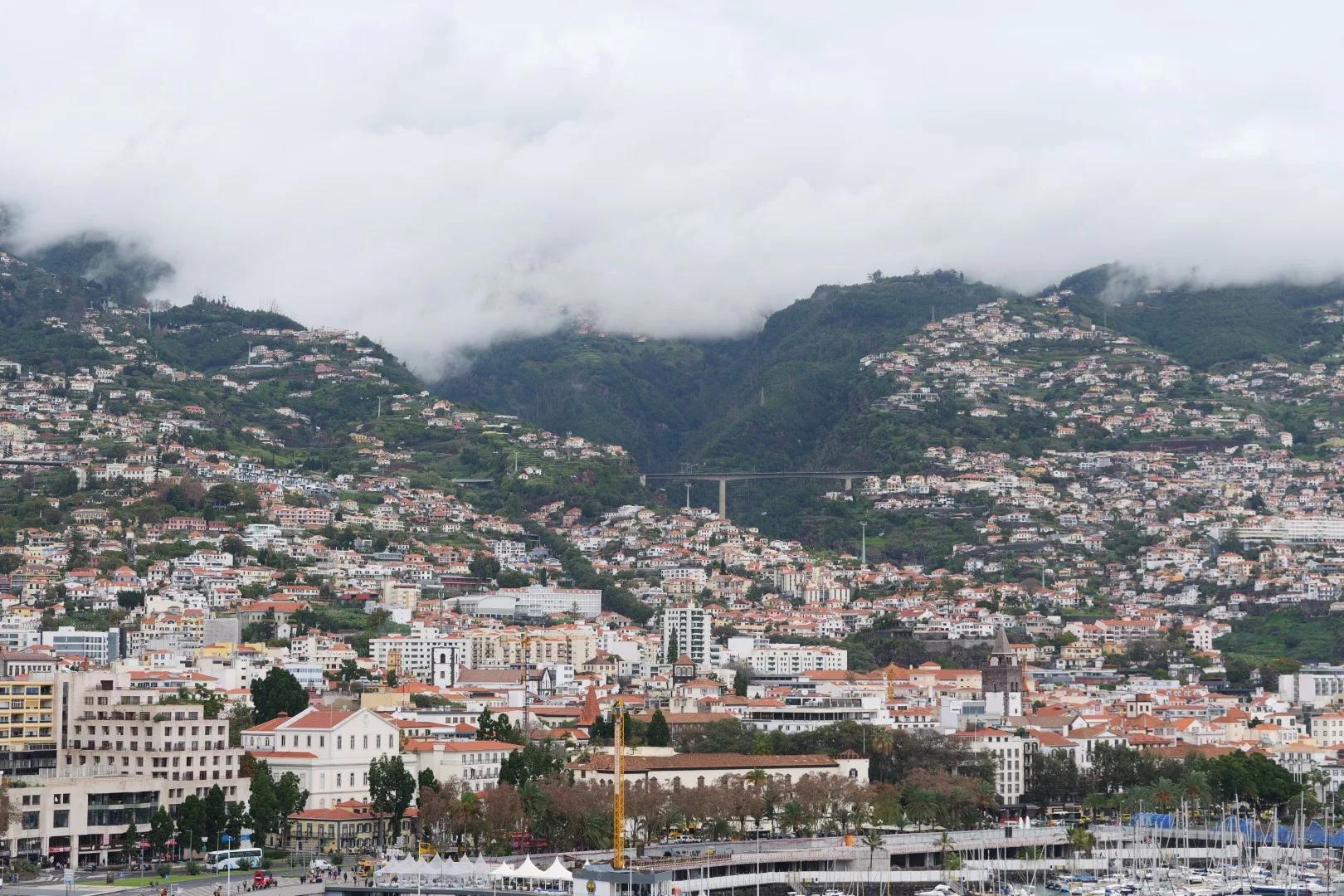 View of Funchal - Madeira’s capital nestled picturesquely against the slopes of the surrounding mountains.