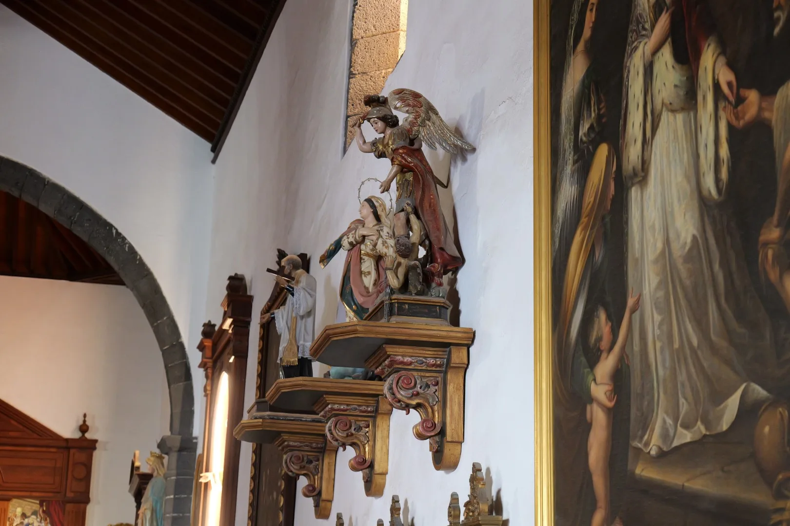 Detailed statues of saints inside the Church of San Ginés in Arrecife.