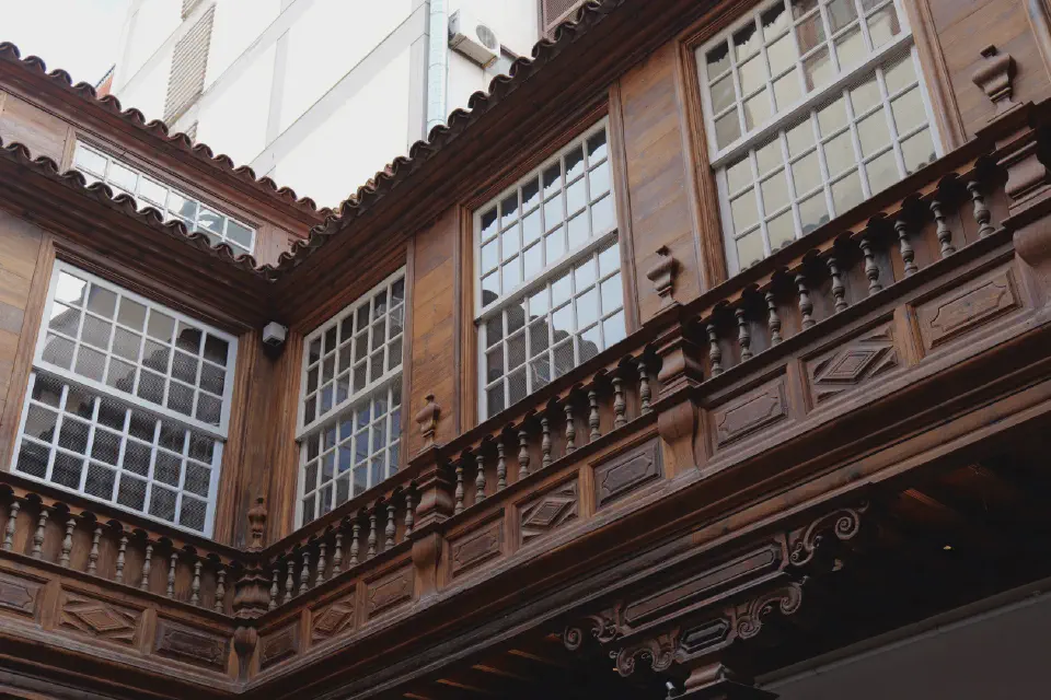 Traditional Canarian wooden architecture in Santa Cruz de Tenerife - intricately carved balconies and window frames in historic style.